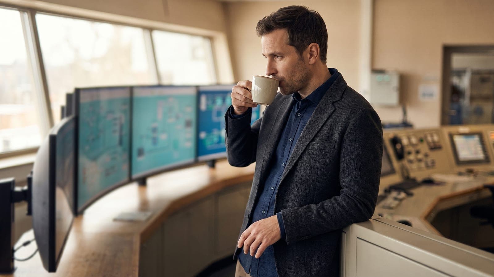 An engineer monitoring an industrial control system in a modern control room.